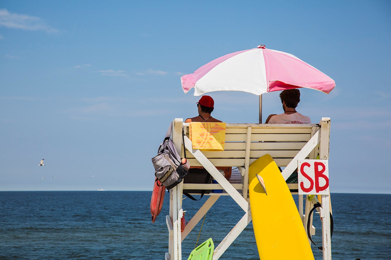 Back view of two lifeguards in a chair