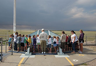 Students surround the Delta-09 missile silo