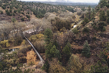 A photo looking down at the Contact Station from the Cliff Dwellings trail with fall foliage visable.