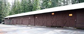 Long brown building with garage like doors