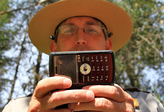 Picture of a Park Ranger using a cell phone