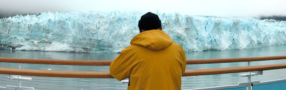 Man viewing a glacier from a cruise ship