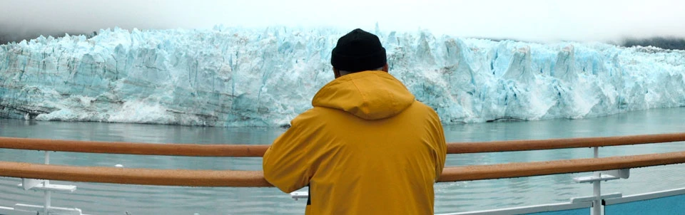 Man viewing a glacier from a cruise ship Man viewing a glacier from a cruise ship