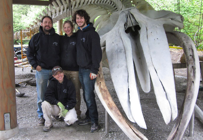 The Whales and Nails articulation team stands proudly in front of the completed skeleton display.