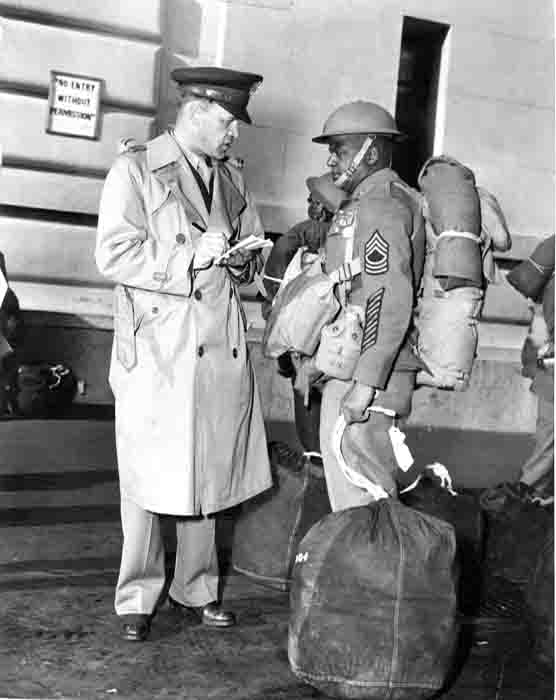 Photo of officer and service man preparing for departure.