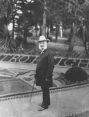 Photo of Adolf Sutro in front of formal gardens, circa 1885.