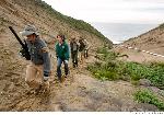 Volunteers ascend from the gulch