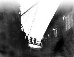 Men crossing the ship's gangplank