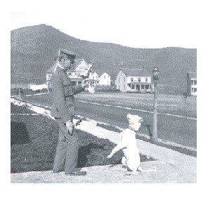 Soldier tempting dog at Fort Baker