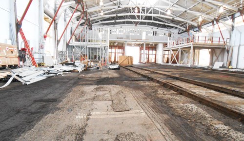 interior of Pier Shed 2 showing historic railroad tracks now unearthed from asphalt