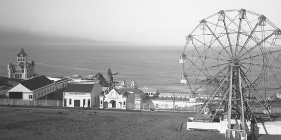 historic image of ferris wheel and small buildings at edge of Pacific Ocean