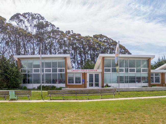 three multistory buildings with many glass windows. Crissy Field Center.