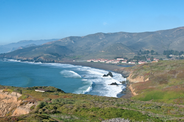 View looking north showing the ocean coastline and historical military buildings at Fort Cronkhite.
