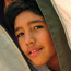 Boy peaking out of tent