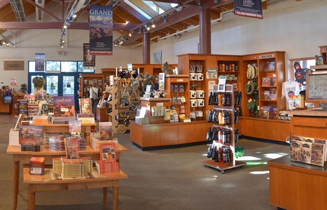 interior of a large store with a number of display fixtures with books and clothing and water bottles