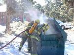 firefighters and dumpster fire