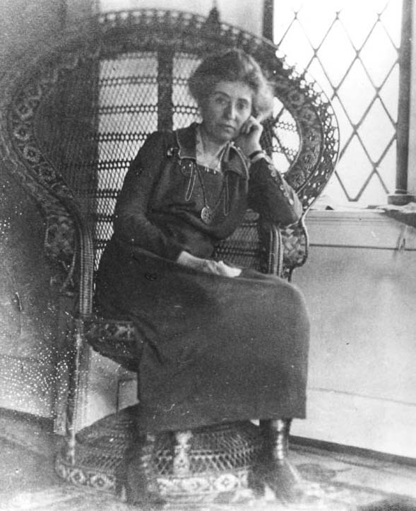 Full shot of Mary Colter in an elaborate wicker chair