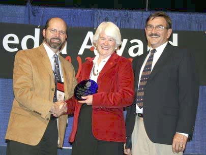 Project Manager Ellen Seeley accepts Grand Canyon’s NAI Media Award from NAI President Jim Covel (left) and Executive Director Tim Merriman.