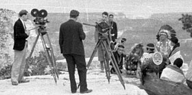 Santa Fe Railroad promotional film being made on S. Rim of Grand Canyon. Hopi House employees pose in costume. Circa 1931. NPS Photo
