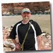 man standing on rocky beach at Colorado River