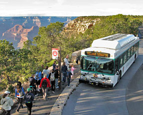 Shuttle bus boarding at Hermits Rest. Canyon beyond.