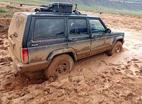 Black SUV stuck in the mud on the way to Tuweep.