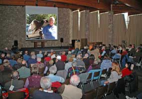 audience watches slide show in the main auditorium