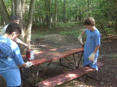 Scouts painting picnic tables in a service project