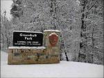 a picture of the entrance sign in the snow