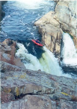 Kayaker running the falls