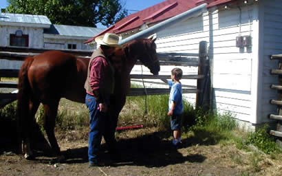 A ranger showing Stony the horse to kids while talking about a cowboy's life.