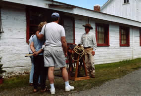 Ranger giving a cowboy talk in front of Bunkhouse Row.