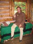An interpreter carves in the Canoe Warehouse.
