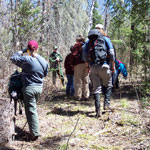 Hikers enjoy a spring exploration of a snowless Grand Portage footpath.
