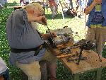 Tinsmithing techniques are demonstrated inside the stockade at Grand Portage National Monument.