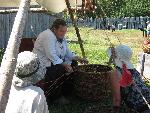 Re-enactor Jackie Bedford demonstrating the craft of making a willow basket.
