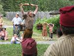 Re-enactor Colton Cheney participates in the water lifting contest.