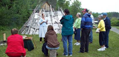 Visitors listen to an interpretive ranger in Grand Portage National Monument's Ojibwe Village.