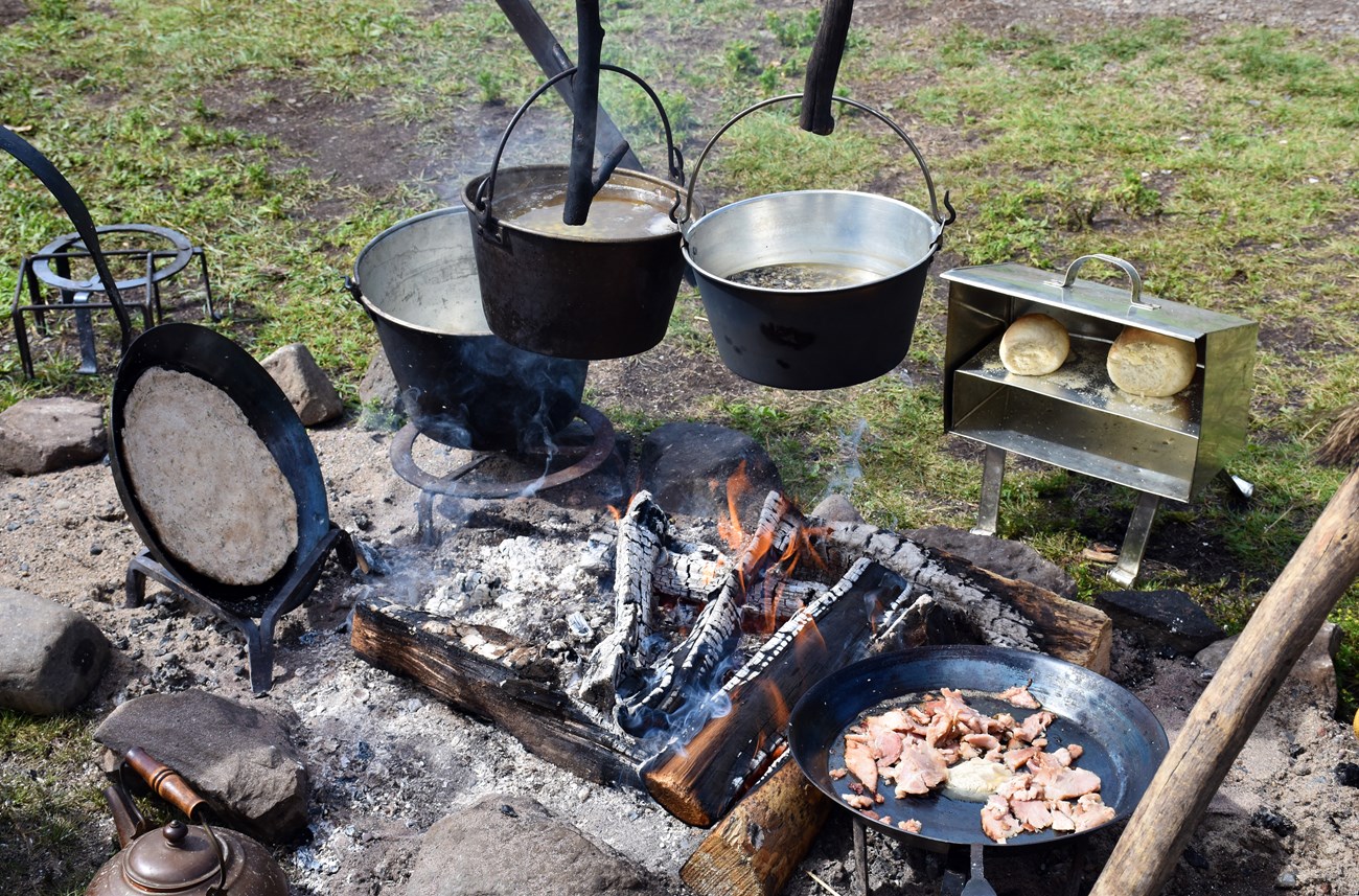 Voyageur food - cooking pots over a fire.