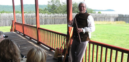 A volunteer interpreter presents a program on the front porch of the Great Hall.