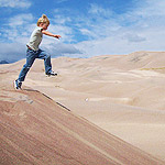 Boy Jumping Off a Dune