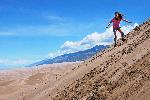 Girl Sandboarding on High Dune