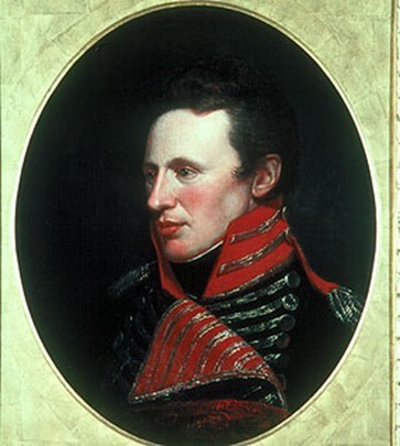 Painting of Zebulon Pike in a gold frame. Pike is a young man wearing a dark military uniform with red and silver trim.im