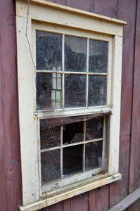 A broken window sheds light on cabins at Elkmont.