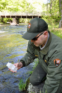 Matt Kulp, fisheries biologist at the park, takes water samples of lower Hazel Creek.