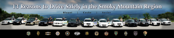 Photo of 13 law enforcement officers from the coalition standing beside their patrol cars.
