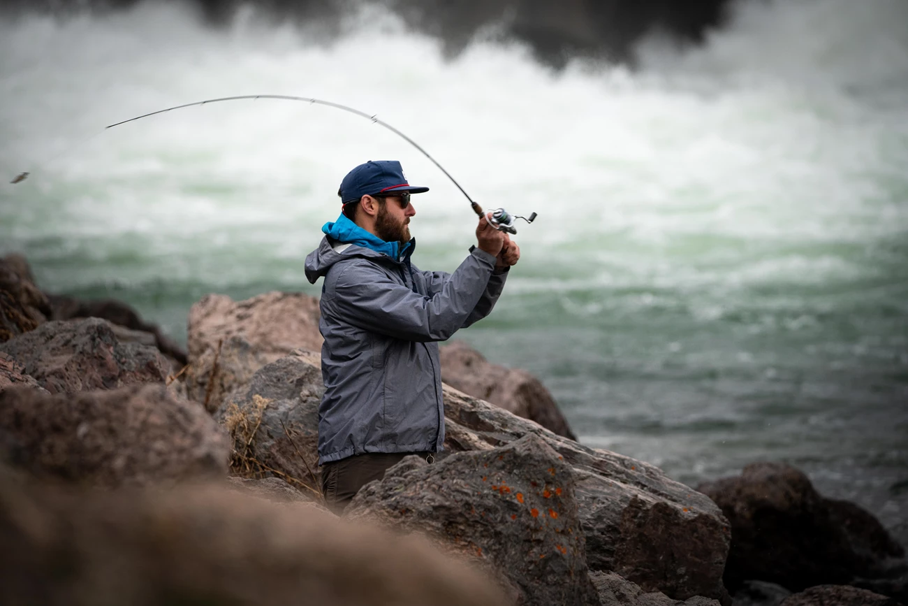 Fishing below Jackson Lake Dam Man fishing the Snake River below Jackson Lake Dam