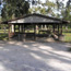 Davis Bayou Pavilion Four shaded with tall trees