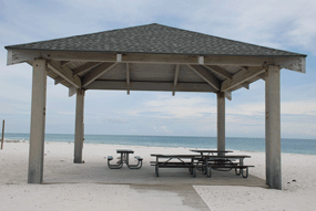 Covered picnic table  with beach in background
