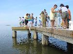 A ranger teaches visitors to throw a cast net.